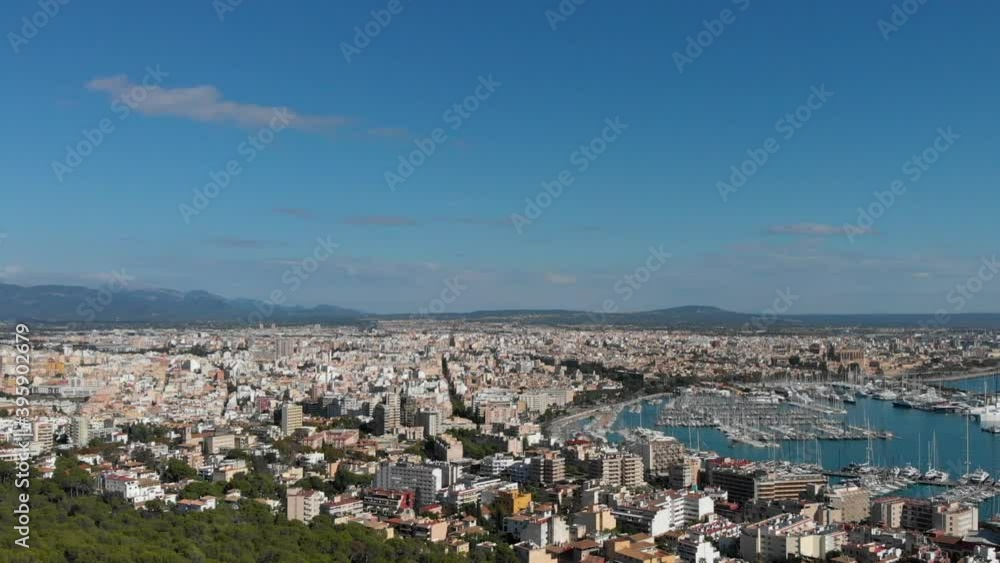 Aerial panoramic view Palma de Majorca cityscape and view to the marina with moored yachts nautical luxury vessels during sunny summer day. Balearic Islands, Espana. Spain