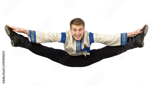 Attractive guy jumping russian in folk costume isolated on white