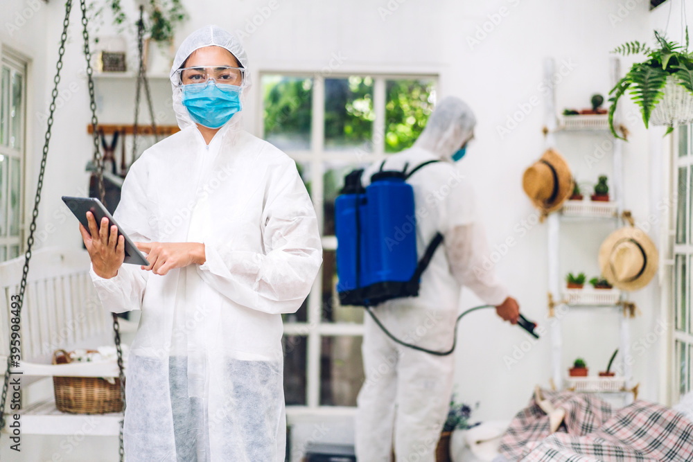 Professional teams for disinfection worker in protective mask and white suit disinfectant spray cleaning virus for help service kill coronavirus at customer home Professional teams for disinfection worker in protective mask and white suit disinfectant spray cleaning virus for help service kill coronavirus at customer home
