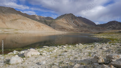 High mountain lake with salt deposit on the shore before sunset between Khargush pass and Pamir Highway in Gorno-Badakshan, the Pamir region of Tajikistan