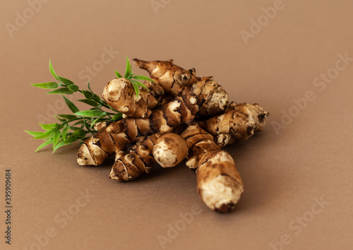 Canvas Print jerusalem artichoke on brown background. Topinambur isolat