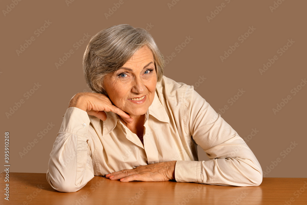 Portrait of happy senior woman at table Portrait of happy senior woman at table