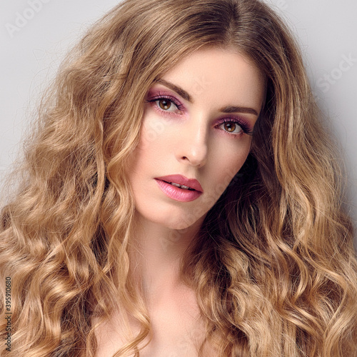 Beauty fashion woman portrait. Gorgeous young blonde with wavy hair healthy skin, makeup. Female face close up. Beautiful smiling model girl, fashionable hairstyle. Skincare make up concept