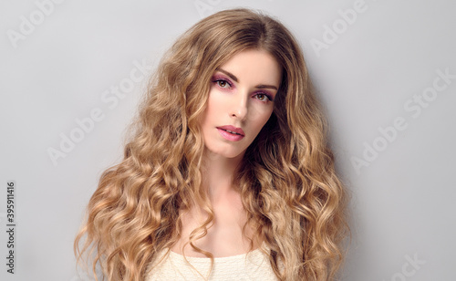 Beauty fashion woman portrait. Gorgeous young blonde with wavy hair healthy skin, makeup. Female face close up. Beautiful smiling model girl, fashionable hairstyle. Skincare make up concept