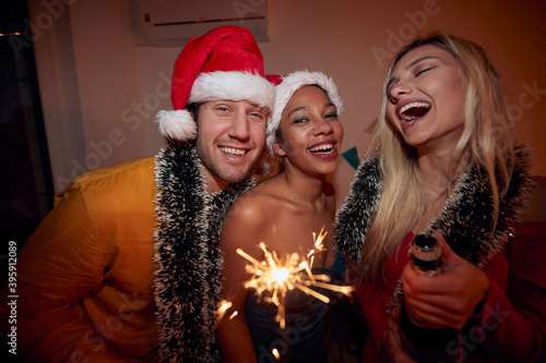 Group of happy friends celebrating New Year