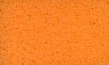 Texture of orange dishwashing sponge. Abstract ornge background.