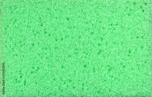 Texture of green dishwashing sponge. Abstract green background.