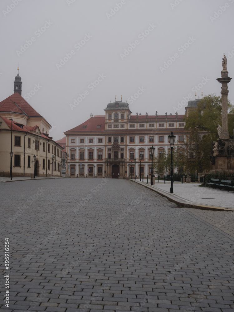 Empty and foggy Hradcanska Square near Prague Castle on an autumn morning