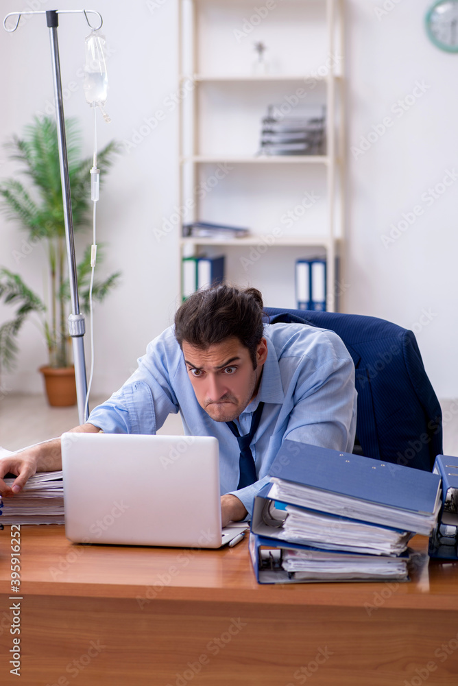 Young male employee suffering at workplace Young male employee suffering at workplace