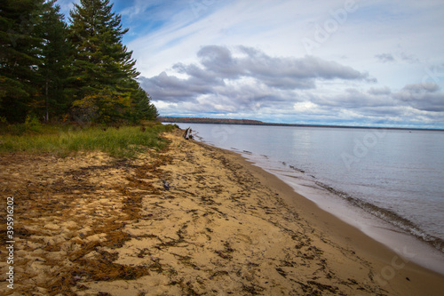 Fototapeta Naklejka Na Ścianę i Meble -   Remote empty beach on a sunny summer day on the coast of Lake Superior on the Whitefish Bay Scenic Byway in the Upper Peninsula of Michigan. 