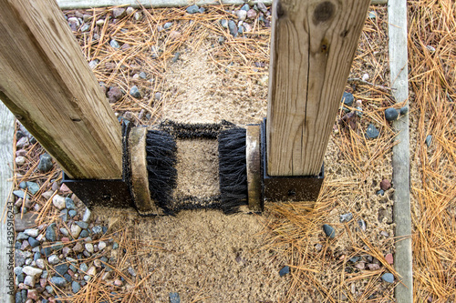 Stop Invasive Species. Boot brush for hikers at a trailhead in the Hiawatha National Forest. The brush allows hikers to brush off their boots to prevent carrying invasive plant species into the woods.