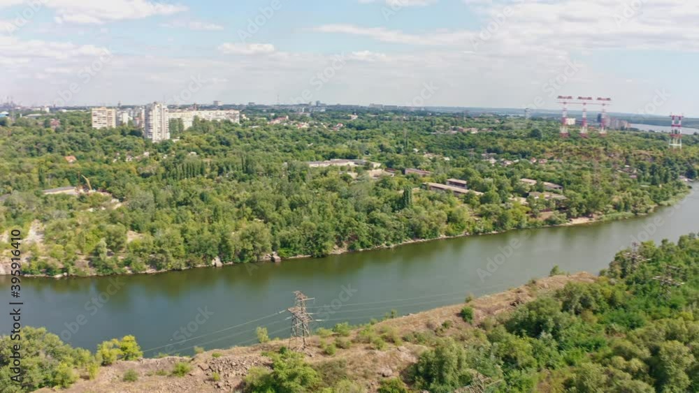 The beautiful river is surrounded by green and fresh vegetation in the city. Dnieper hydroelectric power station in Zaporozhye The beautiful river is surrounded by green and fresh vegetation in the city. Dnieper hydroelectric power station in Zaporozhye