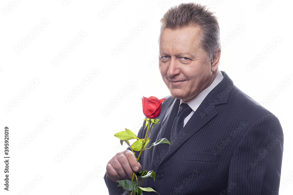 Romantic senior gentleman holding a rose and looking at camera isolated on white background Romantic senior gentleman holding a rose and looking at camera isolated on white background