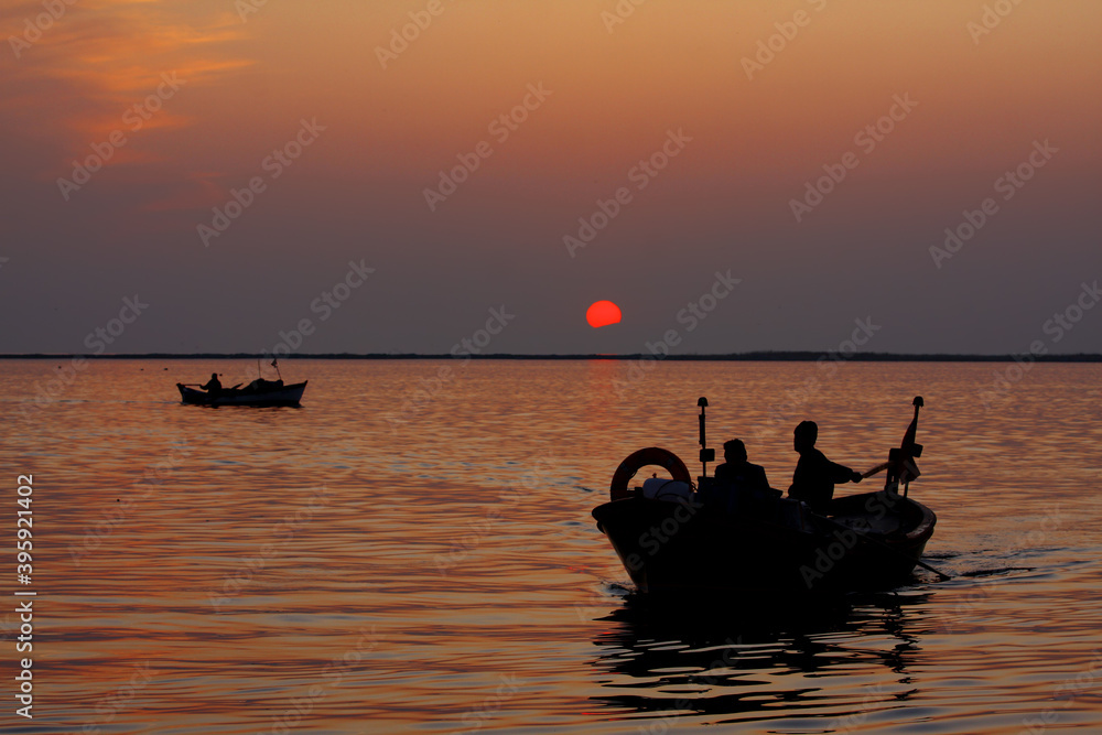 Photos of fishing boats and silhouette of people at sunset