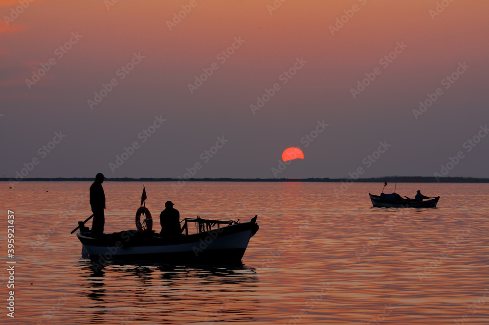 Photos of fishing boats and silhouette of people at sunset