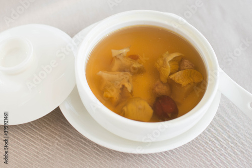 an appetizer of Double-boiled Conch and Red Date Soup served in a white china bowl