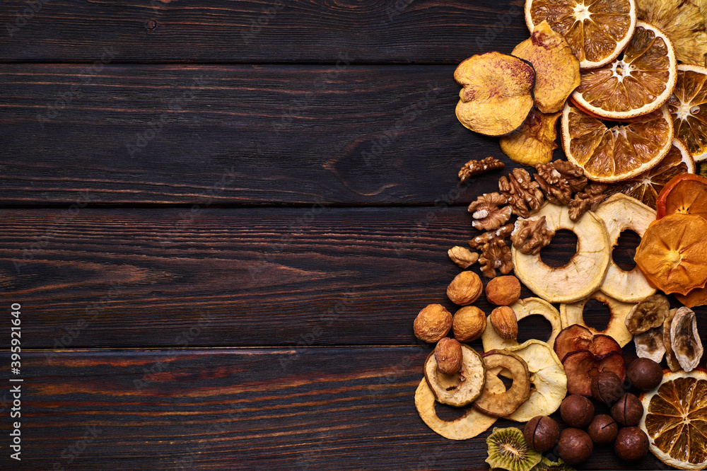 Mix of dried fruits and nuts on a wooden table