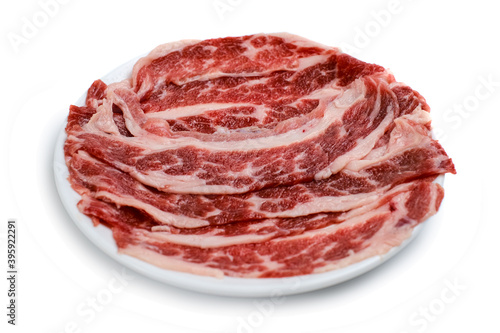 Fresh beef short plate slice on black plate, isolated on white background