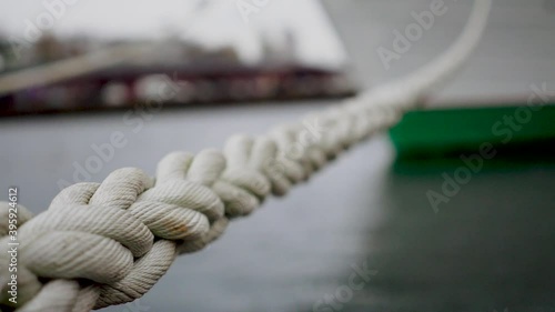 Close-up of part of twisted rope. Macro photography of villi of twisted rope on blurry background. White ship mooring Rope keeps the boat or ship anchored along the shore