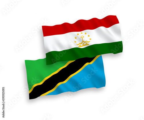 National vector fabric wave flags of Tajikistan and Tanzania isolated on white background. 1 to 2 proportion.