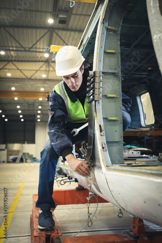Wallpaper Mural Portrait of a Caucasian man , factory engineer in work clothes controlling the work process at the helicopter manufacturer.  Torontodigital.ca