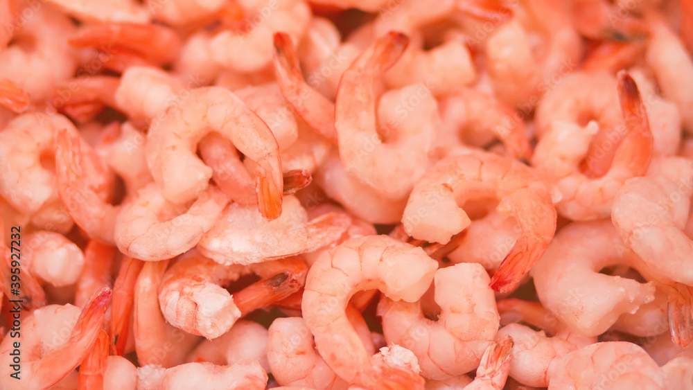 Frozen peeled shrimp are in the grocery store in large quantities. Sale of marine products. Frozen peeled shrimp are in the grocery store in large quantities. Sale of marine products.