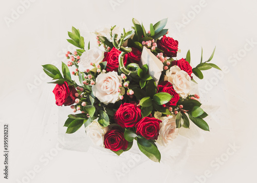 A spring flower arrangement with both red and white naomi roses