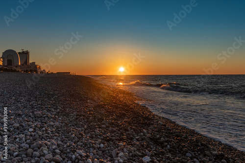Small waves at sunset on the autumn beach