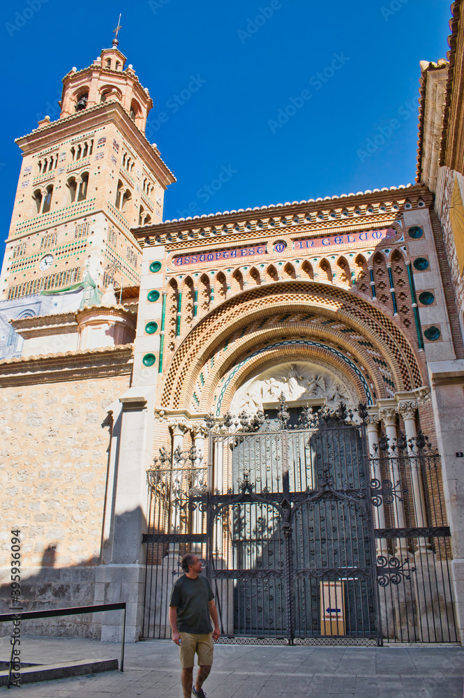 Taking a walk in front of the Mudejar style facade of Teruel Cathedral