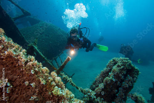 Diver exploreds the shipwreck.