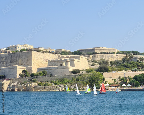 Valletta, Malta - September 18th 2020: Sailing boats in Marsamxett Harbour in front of St. Michael's Bastion and St Michael's Counterguard. photo