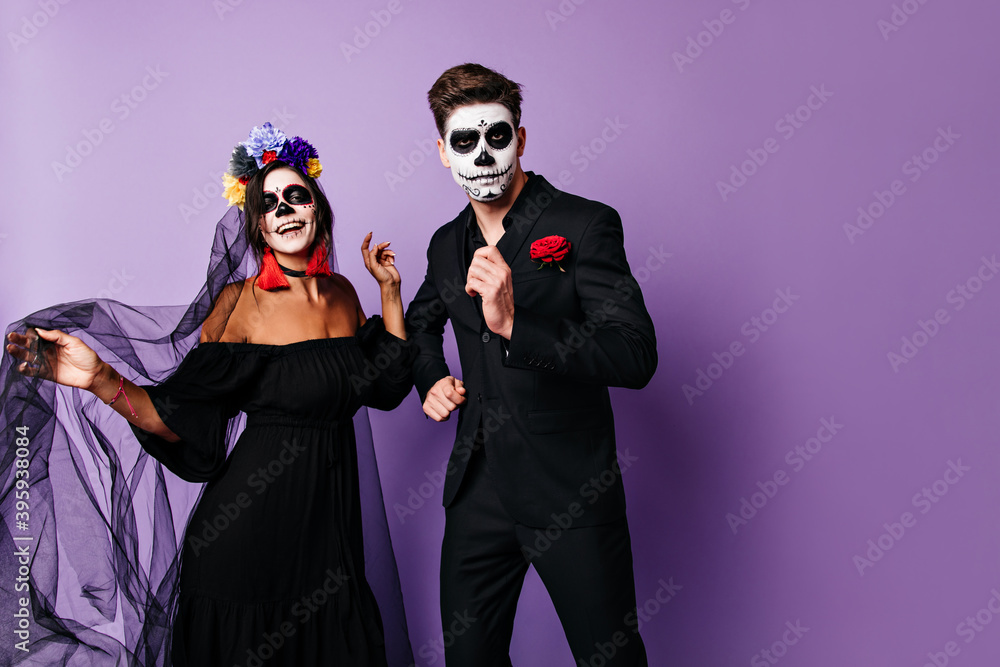 Perky men and his woman in black outfits have fun and dance at Halloween party Perky men and his woman in black outfits have fun and dance at Halloween party
