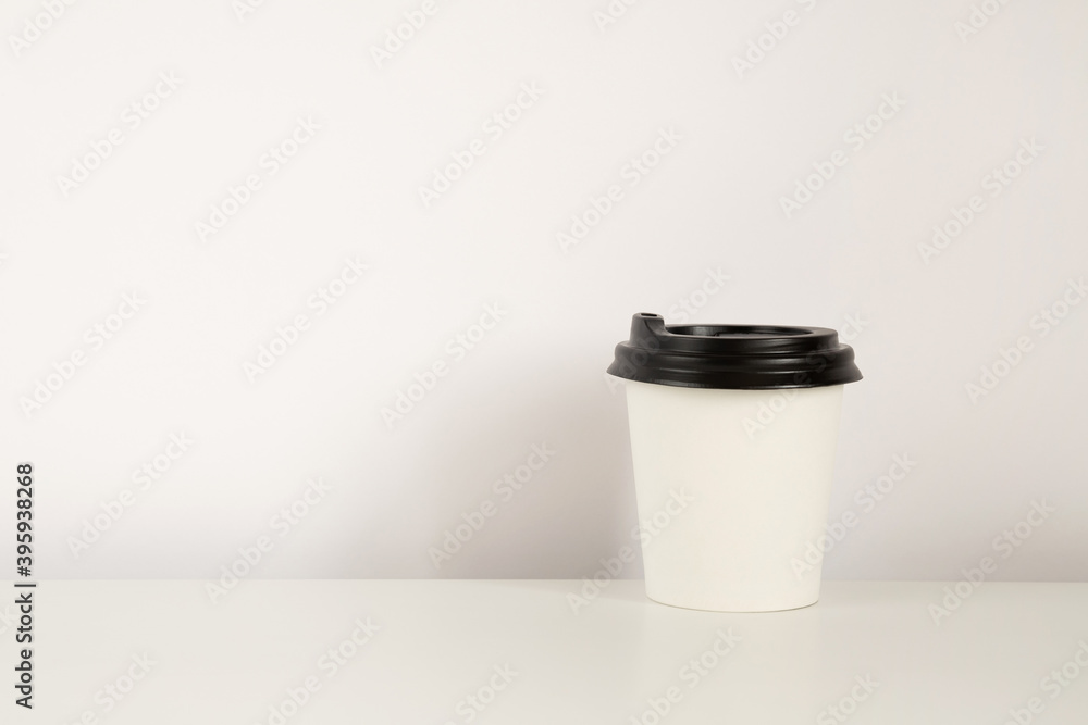Coffee cup mockup on the white background. Empty cup for americano on the table with copy space Coffee cup mockup on the white background. Empty cup for americano on the table with copy space
