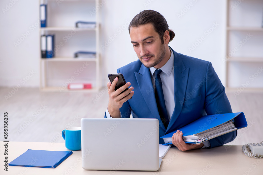 Young male employee working at workplace Young male employee working at workplace