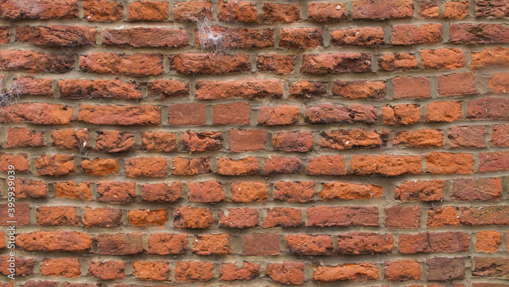 Rustic old red brick wall background with grey mortar between bricks Rustic old red brick wall background with grey mortar between bricks