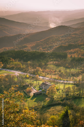 Vertical shot of a building and trees in a mountainous area photo