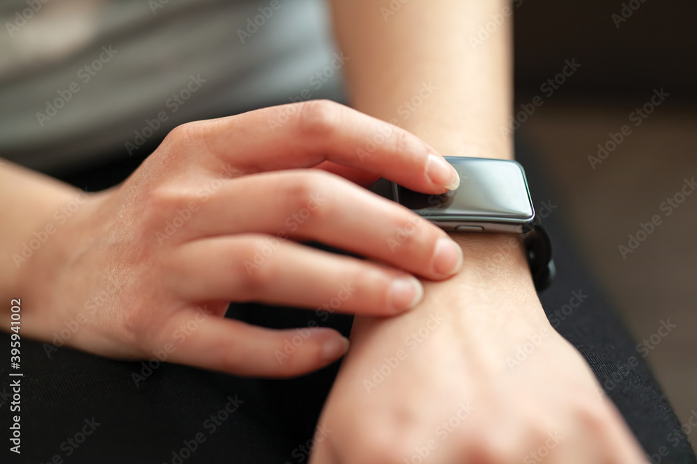 Close-up of a woman checking time on her smart watch.Modern clock concept.Background woman hand wear wrist watch.
