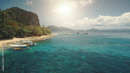 Sun sand beach at green mountain island aerial. Passenger boats at tropic paradise isle nature landscape. Amazing greenery exotic plants and trees. People admire tropical cruise