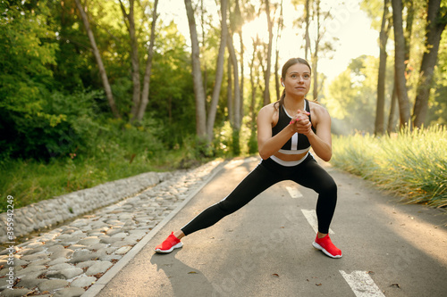 Training in park, woman prepares for running