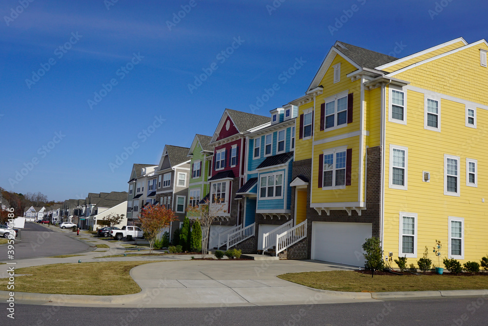 Neighborhood street lined with multicolored townhouses