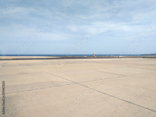 Runway, Airport pavement close up. Seaside airport runway background. View to empty airport runway. Aeronautical engineering concept. © Su Nitram