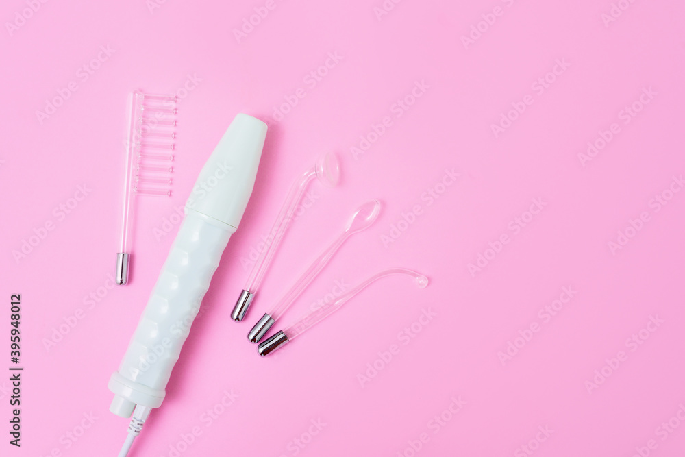 darsonval on a pink background, taking care of yourself at home . medical device for the treatment of acne, cellulite, hair at home and in Spa centers. space for text, top view