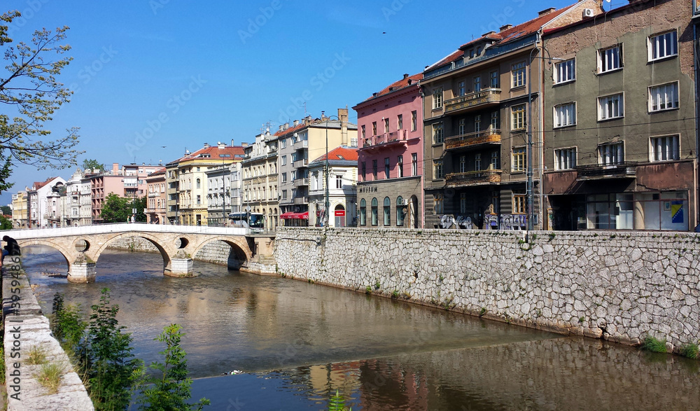 Sarajevo, Bosnia and Herzegovina - June 25, 2017: Latin Bridge and the houses on the river in Sarajevo.