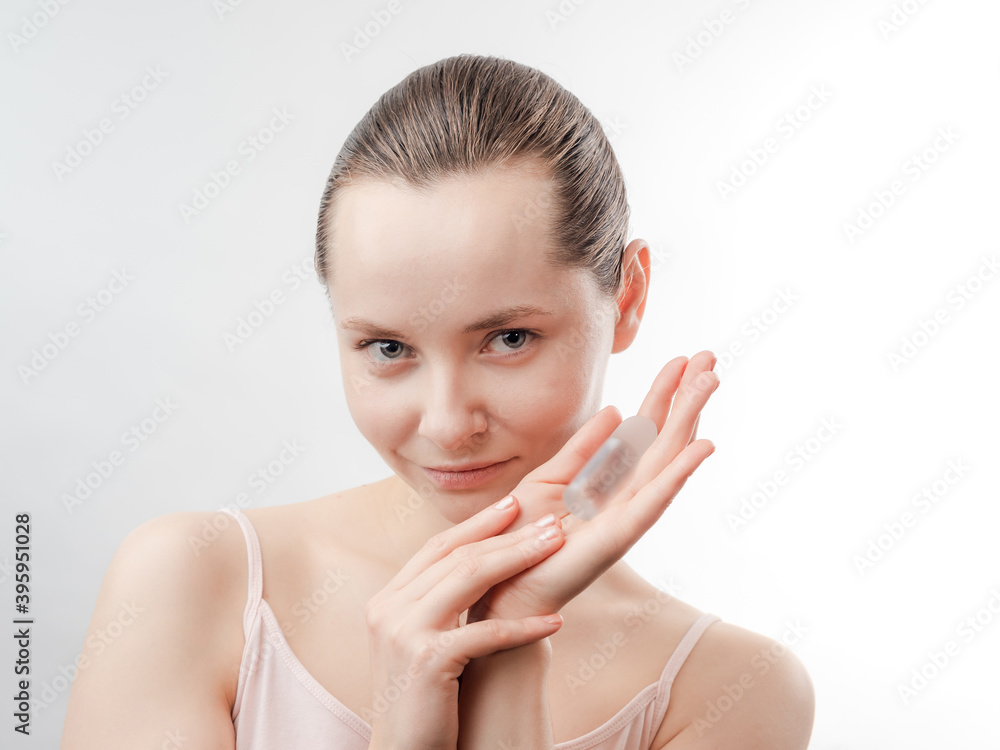 Beautiful Young Woman with Clean Fresh Skin showing the product for skin care. Girl beauty face care. Facial treatment . Cosmetology , Beautiful Young Woman with Clean Fresh Skin showing the product for skin care. Girl beauty face care. Facial treatment . Cosmetology ,