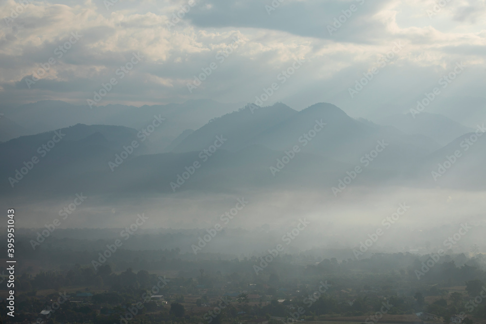 beautiful mountain scape behind small community with mist in the morning at Pai, Mae Hong Son, Thailand