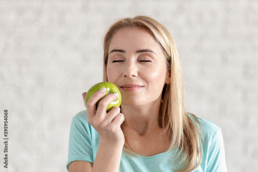 Beautiful young woman portrait with green apple. The concept of healthy food, healthy body care Beautiful young woman portrait with green apple. The concept of healthy food, healthy body care