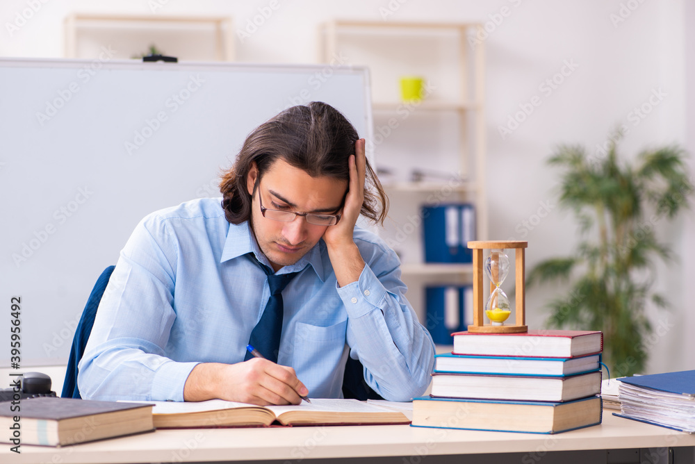 Young businessman student in time management concept Young businessman student in time management concept