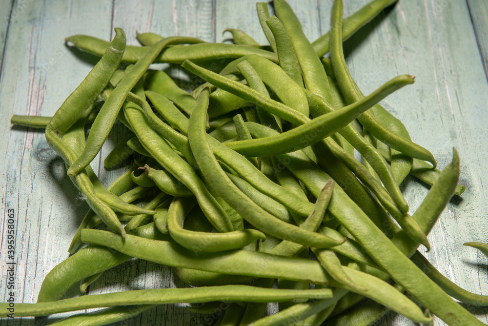 Green beans on a green wooden rustic background Green beans on a green wooden rustic background