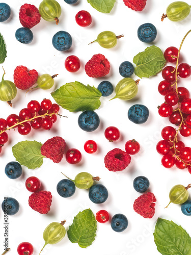 Various fresh summer berries background. Pattern of fresh blueberries, red currant, raspberries, gooseberries isolated on white background. Top view or flat-lay. Vertical.