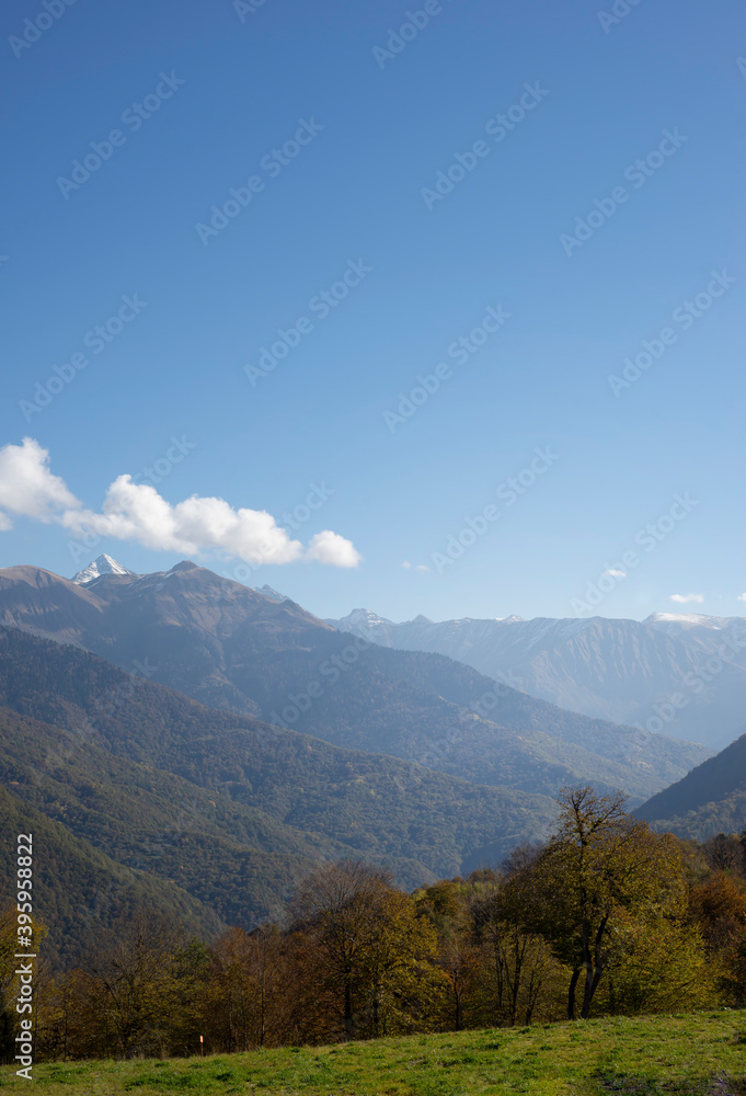  Mountain landscape against the blue sky. Vertical postcard with place for text.